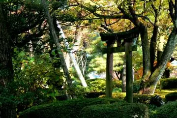 <p>A stone torii standing in the garden</p>
