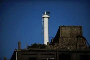 <p>A white tower and a water tank stand on a hill; They used to extract drinking water from seawater at first, but later, drinking water was carried to the island and stocked here in the tank</p>