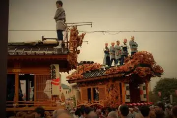 <p>Tough guys stand atop the floats, trying to intimidate other teams before battle</p>