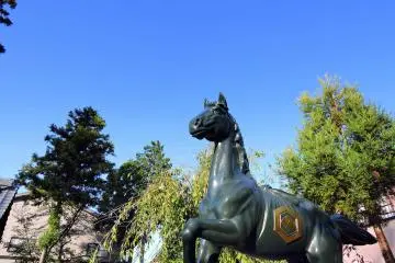 <p>Statue of sacred horse standing high on the shrine grounds</p>