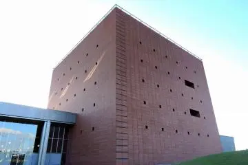 <p>Beautiful brick-color building standing high in the sky</p>