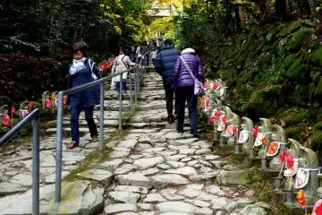 <p>The temple is reached by a path lined with ojizo statues</p>