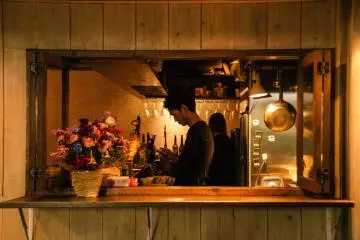 <p>Window over looking inside a bar.</p>