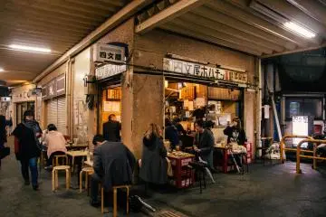 <p>Locals grab a drink and a bite to eat at this small joint under the train station.</p>