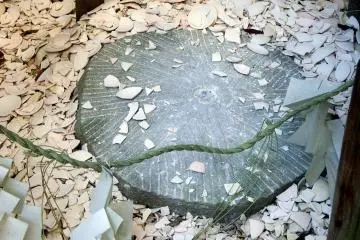 Fragments of white cups smashed on the stone