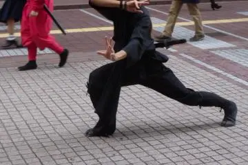 <p>A Date Bushotai member poses for photos during a lull in the parade &nbsp;</p>