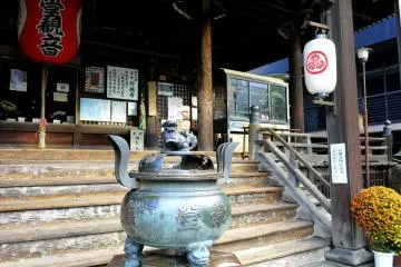 <p>A guard dog sits on top of the insence burner</p>