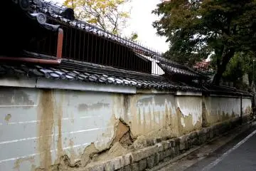<p>The plaster is crumbling away on the wall facing the street</p>