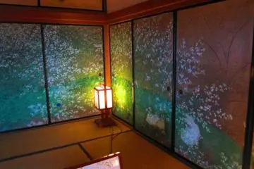 Brightly colored cherry blossoms decorate a wall-screen inside