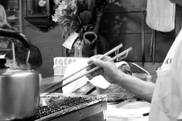 Long chopsticks are used to prevent the chefs from burning their hands when turning over the guytan