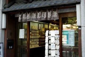 <p>Hand painted postcards on a rack outside the door. I love the handkerchief-sized door curtains with Japanese writing on them. &nbsp;</p>