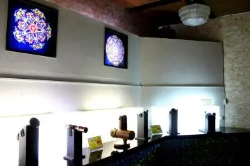 <p>By the wall, you will see the symmetrical colors and light formations from some of the kaleidoscopes captured in enlarged pictures.</p>