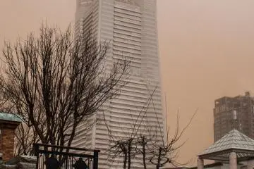 The sky's brownish color is actually red sand from China!