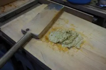 <p>Beating the bark from left to right</p>