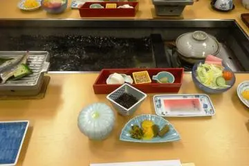 <p>A shot of part of breakfast - the middle of the table is filled with hot spring water used to boil your breakfast eggs</p>