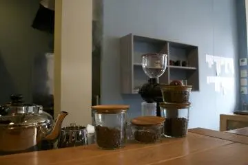<p>Fresh coffee beans by the counter</p>