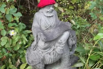 What is it that this old lad is sitting on?