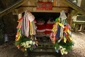 <p>A small altar with multi-colored cranes. According to an ancient Japanese legend, anyone who folds a thousand origami cranes will be granted a wish by a crane. Cranes also symbolize hope and joy.</p>