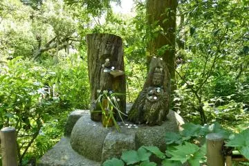 Some wooden carvings amongst the trees.