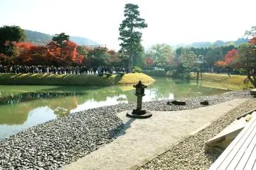 <p>The view seen from central chamber of Phoenix Hall. On the opposite side of the pond there is a long line of people waiting for their turn to enter the Phoenix Hall</p>