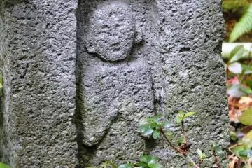 The carving at the bottom of one of the garden's lanterns, indicating the garden owner was a hidden Christian