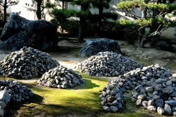 <p>Small mounds of stones were positioned on moss in the garden</p>