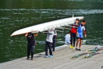 <p>Several kayakers putting away their kayak after a practice session</p>