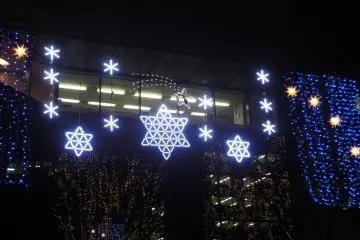 <p>&nbsp;Illuminations hang on the facade of a building along Jozenji Avenue</p>
