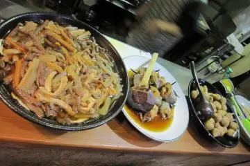 카운터 위 큰 접시에는 바로 내줄 수 있는 요리가 몇 종류. 어느 것이든 그리운 가정 요리이다