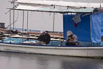 Fisherman take an afternoon nap in their boats (Photo: John Fowler)