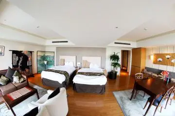 <p>This is the view from near the TV looking out at the two beds: the beautiful kimono and painting on display on the left side of the photo and the door to the room on the right side.&nbsp;</p>