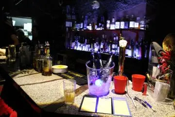 <p>Bar is just behind the seating, serving both food and drinks</p>