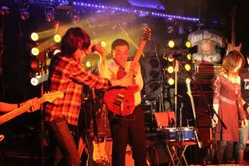 <p>Ready to try his hand on the guitar, this volunteer started out a bit timid</p>