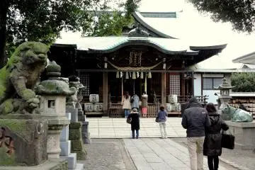 <p>Visitors pray at the main shrine building</p>