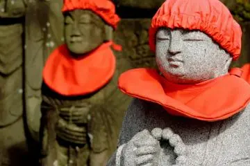 <p>O-Jizo statues in red hats and aprons</p>
