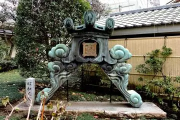 <p>This beautifully ornate apex tile was standing in the garden - possibly from a previous incarnation of the main hall</p>