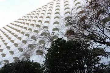 <p>Looking up at the hotel building from the Japanese Garden. You can see each room has a veranda.</p>