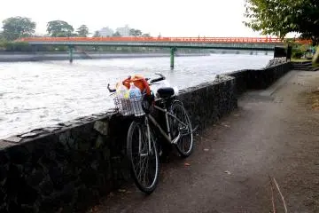 <p>My bike leaning against the stone wall along the river bank at Uji</p>