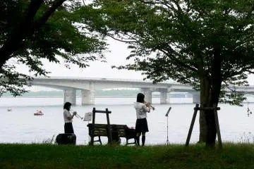 High school students enjoying music practice beside the lake