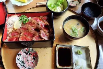 <p>Have the Gyu-katsu-ju, a melt-in-your-mouth beef cutlet, very lightly battered and deep fried - served over rice. It comes with miso soup, pickles, and potato salad. It was amazing!</p>