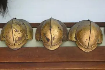 <p>Old helmets hanging in the estate's main hallway</p>