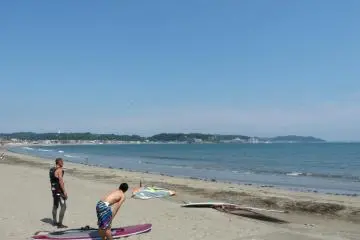 Surfers limbering up before entering the water