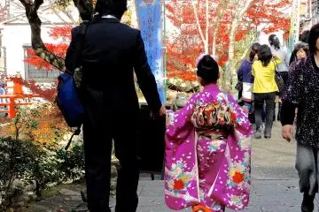 <p>A father and his daughter on their way to one of Miyajima Island's temples or shrines</p>