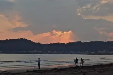 A fisherman at dusk enjoying the sunset