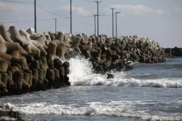 <p>Small waves crash against the shore</p>
