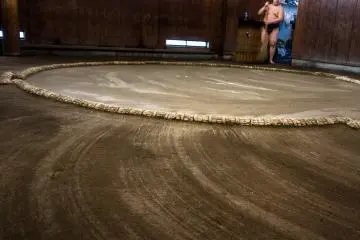 <p>A skillfully swept Sumo ring closes their morning training session</p>