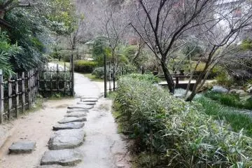 <p>A stone path leads around the rear of the property</p>