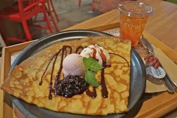 <p>Enjoy a brown-sugared crepe topped with sakura flavored ice cream, sweet red bean, a dollop of cream, and drizzled with chocolate sauce at Red Brick Warehouse.</p>