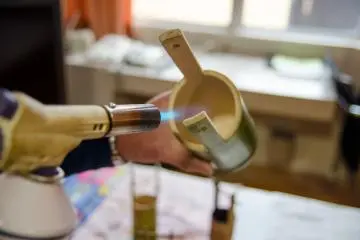 <p>Removing mold from inside the bamboo with torch&nbsp;</p>