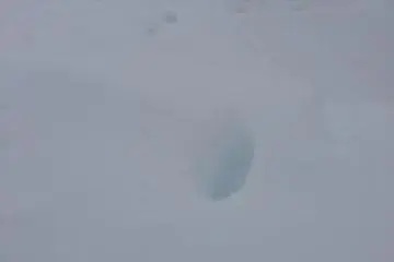 <p>There was so much snow that deep within my boot prints it looked blue.</p>